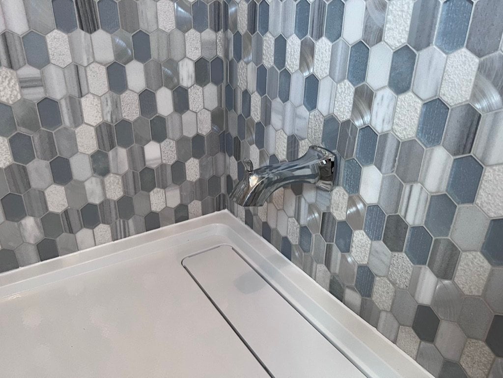 Hexagonal mosaic tile detail in a shower installation